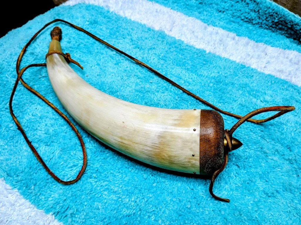 Powder Horn made from a bull or buffalo horn for holding gun powder for a muzzleloader.